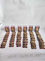 Six booster display boxes with rows of booster packs