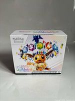 Front and top of Pokémon Prismatic Evolutions Elite Trainer Box