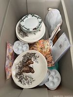 top view inside tote showing plates, egg trays, puzzle, pillow