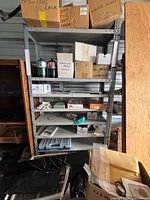 Full view of grey metal shelving unit showing six shelves and frame