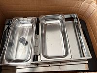 Top view showing warming tray base with two stainless pans and clear lid