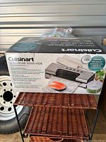 Retail box showing Cuisinart professional vacuum sealer and included rolls