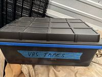 Closed plastic tote labelled VHS TAPES