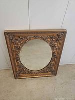 Full front view of framed oval mirror
