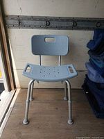 Front view of shower chair showing seat, backrest and legs