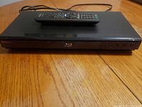Front view of Sony Blu-ray player with remote on top