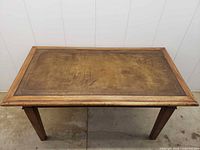 Full top view of wooden table with leather inset