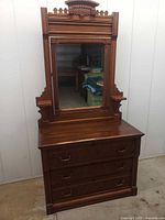 Front view of dresser showing three drawers and full mirror