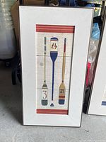 Front view of red-accent paddle print in frame