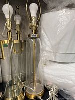 Group of four glass gold table lamps with stacked white shades