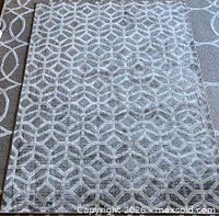 Full view of rug laid flat showing overall geometric pattern