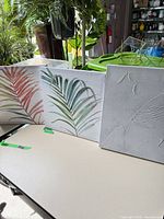 Front view of three canvas artworks showing designs and relative sizes