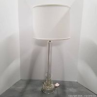 Full view of one lamp with shade showing height and style