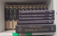 Books on shelf showing Agatha Christie titles, Treasury of American Poetry, and matching tan cloth volumes