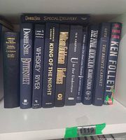 Shelf view of all 11 blue spined hardcover books