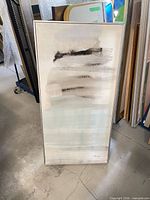 Full view of framed abstract canvas art standing vertically