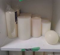 All nine white candles arranged on shelf