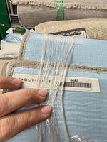 Rolled rug showing backing and texture