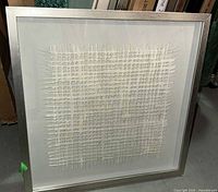 Full view of framed art showing design and silver frame