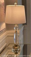 Lamp on glass table with shade attached