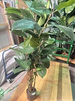 Full view of artificial tree in plastic pot