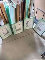 All four framed prints standing together with protective edging