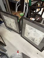 Both framed prints leaning on floor showing size and matching design