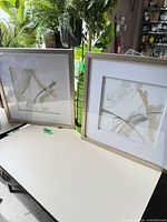 Two framed abstract art prints side by side