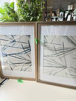 Two framed bamboo wallpaper prints side by side showing full view