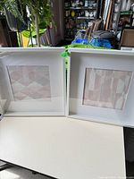 Both framed abstract artworks side by side