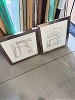 Both framed artworks standing side by side