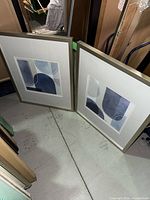 Both framed prints standing side by side showing full frames