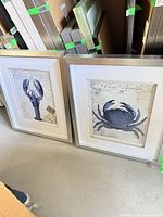 Both framed prints standing side by side