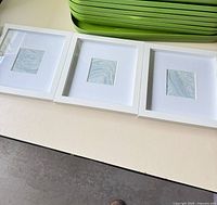 Three framed abstract prints side by side