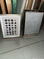 Both framed artworks standing side by side