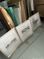 Three framed Golden Kelp prints leaning against wall