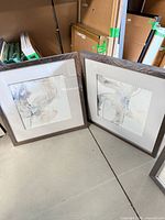 Two Divination framed prints leaning together showing overall design and size