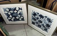 Both framed geometric artworks side by side