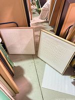 Both framed canvases standing side by side showing size, frames, and overall designs