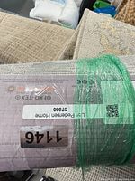 rug rolled with auction label showing certification text
