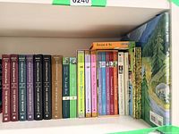 Shelf showing all 25 children’s books including Unfortunate Events set, Frog Princess series, and other titles