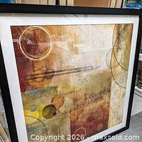 Front view of framed abstract artwork showing composition and frame