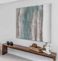 Full view of canvas hanging on wall above bench