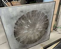 Front angled view of framed canvas showing silver sand dollar design