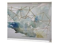 Close view of framed abstract art showing watercolor colors and gold geometric lines