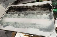 Canvas lying flat showing full abstract artwork and frame corner with artist signature