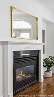 Mirror displayed above fireplace showing orientation