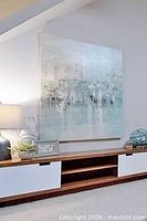 framed view of large soft green abstract canvas displayed on wall