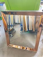 Front view of rectangular mirror with rose-gold mirrored frame