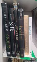 Spine view of six hardcover books on shelf